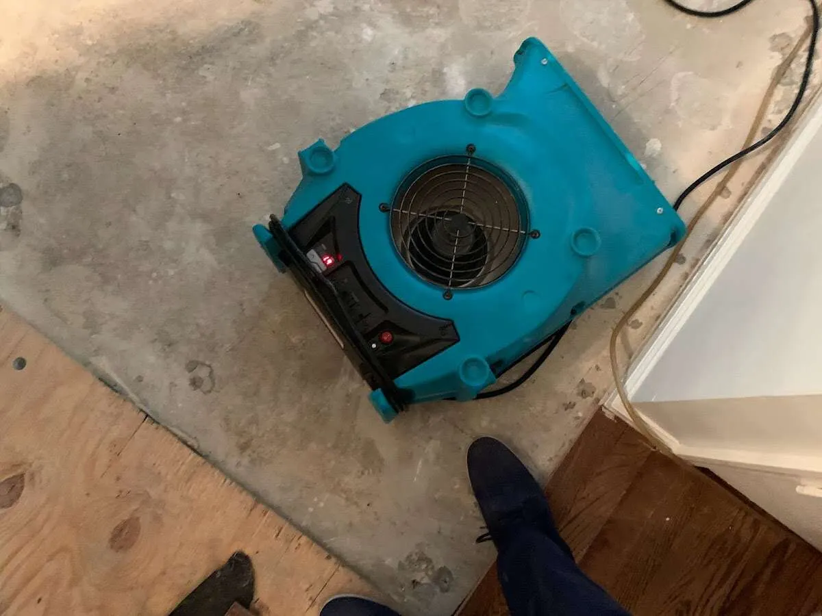 Air mover drying subfloor during Commercial Water Damage Restoration in Fruitland